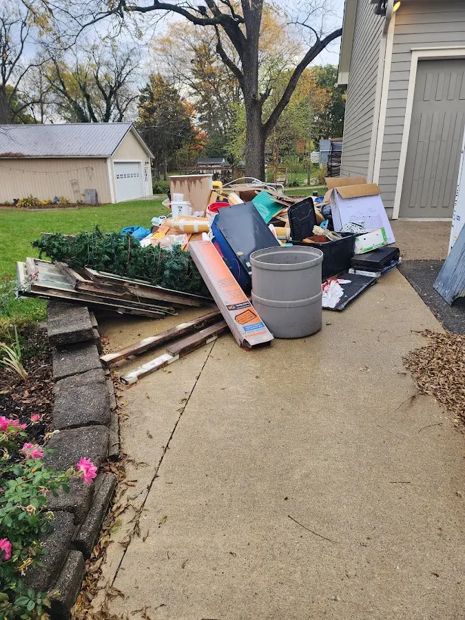 Dumpster being loaded with debris for 10 Yard Dumpster Rental in Charter Oak